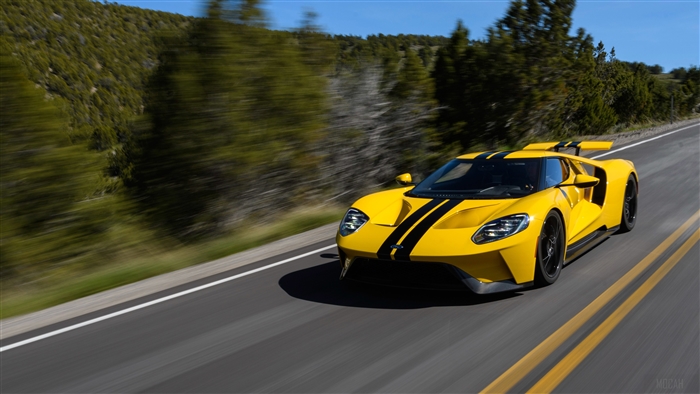 Yellow Ford GT driving on a road