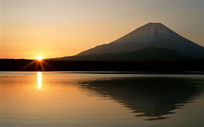 Mount Fuji reflected in a lake at sunrise