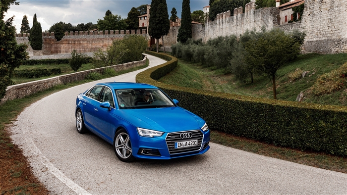 Blue Audi A4 TFSI Quattro driving on a road