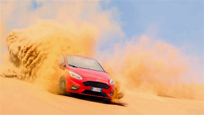 Red Ford Fiesta drifting in desert sand 4K