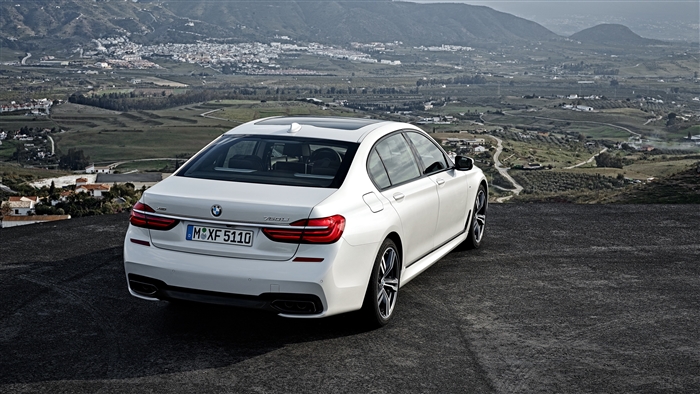 White BMW 750Li xDrive rear view 4K