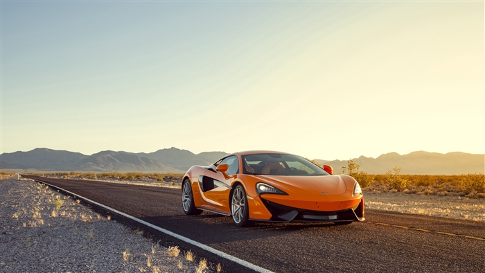 Orange McLaren 570S sports car on desert road