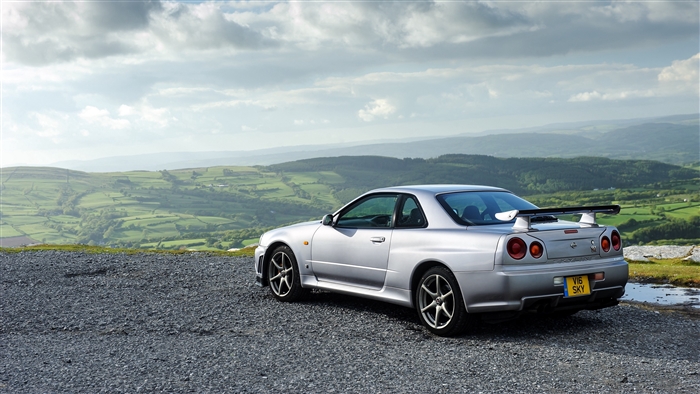 Silver Nissan Skyline GT-R parked on a gravel overlook