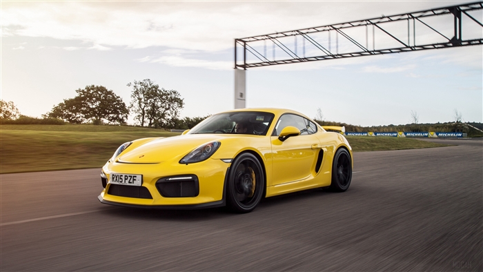 Yellow Porsche Cayman GT4 on a Racetrack