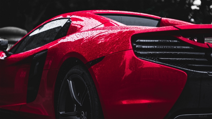Red sports car with water drops