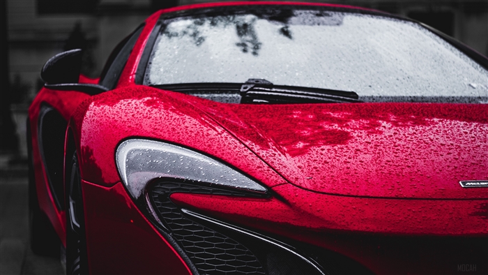Red McLaren car with water drops
