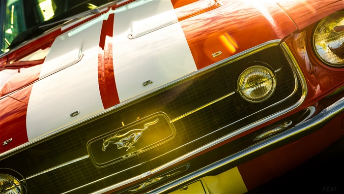 Red 1967 Ford Mustang Fastback with racing stripes
