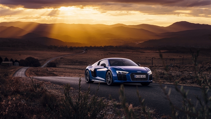 Blue Audi R8 V10 on a winding road at sunset 4K