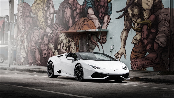 White Lamborghini Huracan parked in front of a mural