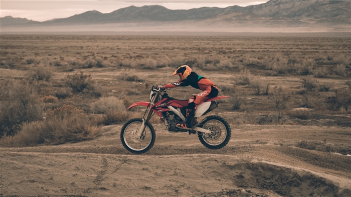 Motocross rider jumping in a desert landscape
