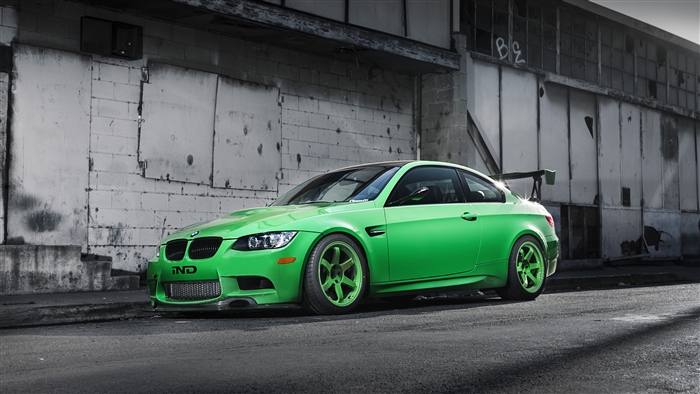 Green BMW M3 E92 with a wing in front of a building 4K
