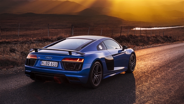 Blue Audi R8 V10 on a road at sunset