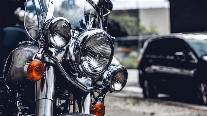 Close-up of a motorcycle's chrome headlights and orange turn signals