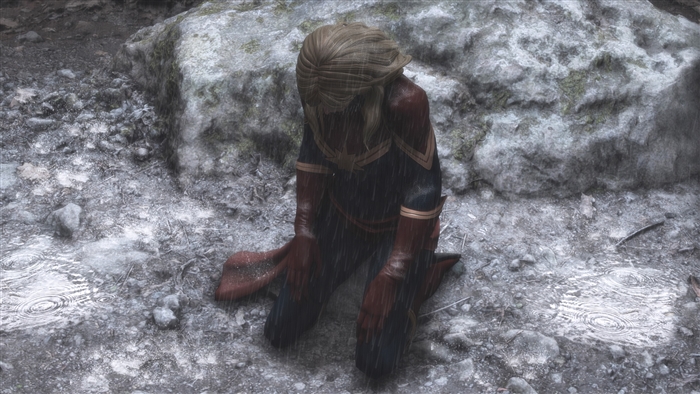 Captain Marvel kneeling in the rain