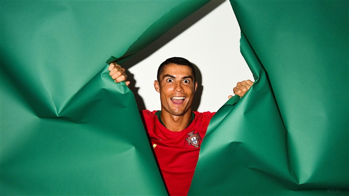 Cristiano Ronaldo of Portugal peeking through green paper