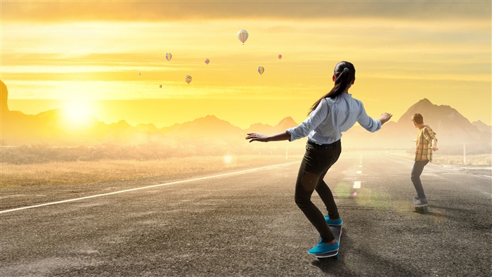 Girl and Boy Skateboarding on Road at Sunrise 4K