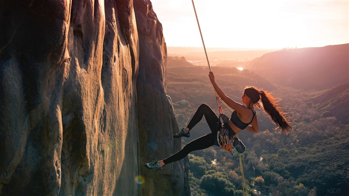 Girl Rock Climber Scaling Mountain at Sunset 4K