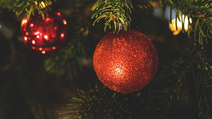 Red glitter Christmas ornaments on a tree