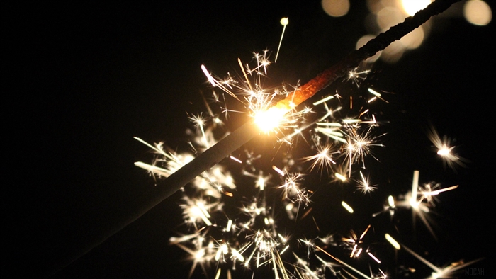 Sparkler with sparks and bokeh 4K