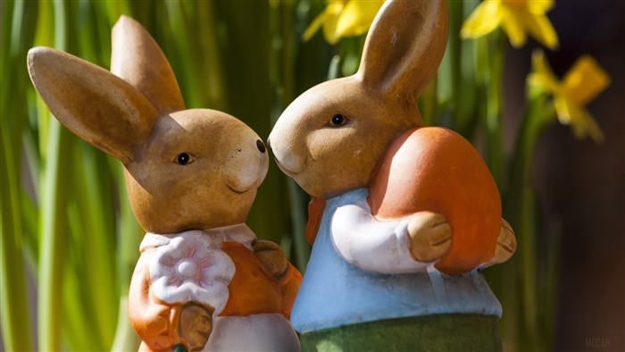 Easter bunnies with orange egg and daffodils