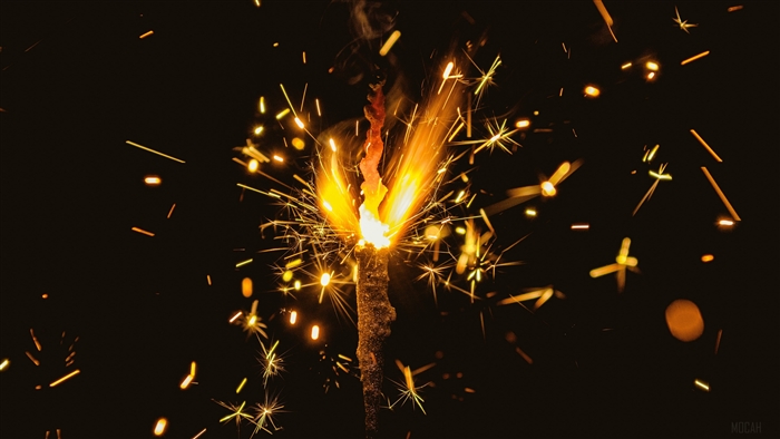 Bengal fire with sparks on dark background 4K