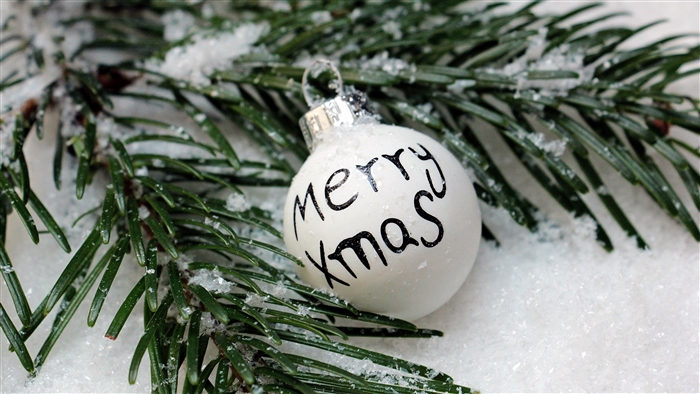 Christmas ornament with Merry Xmas text on spruce branch