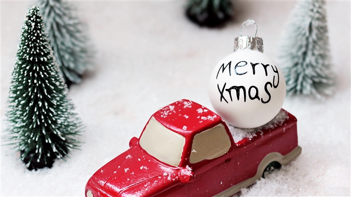 Christmas ornament on red toy truck with trees