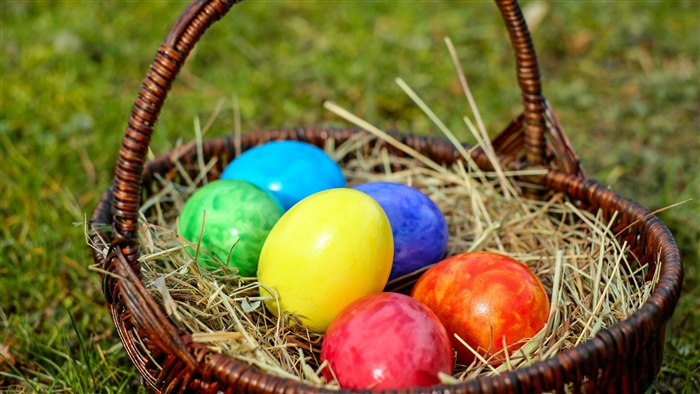 Easter eggs in a basket with hay