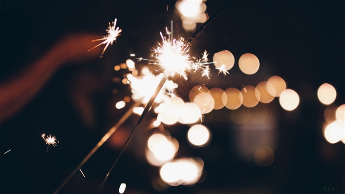 Sparklers and bokeh lights at night