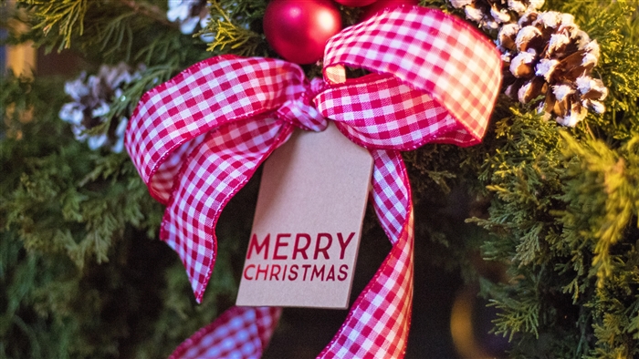 Christmas wreath with red bow and tag