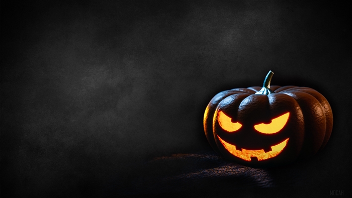 Scary Jack-o'-lantern pumpkin with glowing eyes on a dark background