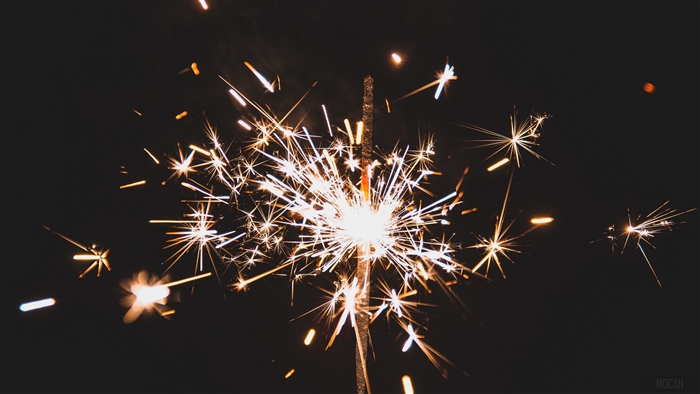Sparkler with sparks on dark background 4K