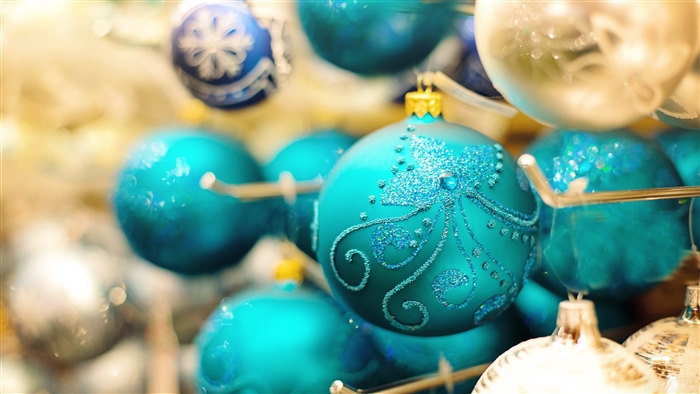 Turquoise and silver Christmas ornaments with glitter patterns