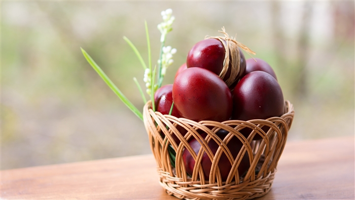 Red Easter Eggs in a Basket with Flowers