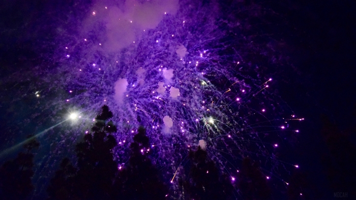 Purple fireworks salute in the night sky 4K