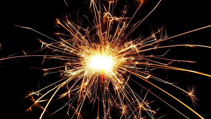 Sparkler with bright sparks on black background 4K