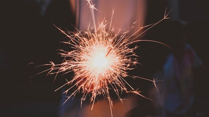 Sparkler with sparks and bokeh 4K