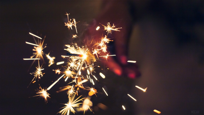 Sparklers held by a hand in the dark