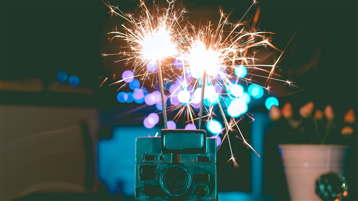 Sparklers on a camera with bokeh lights