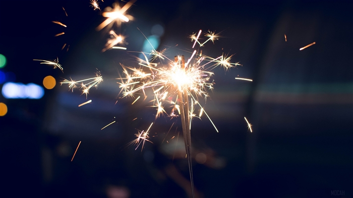 Sparkler with sparks and bokeh lights