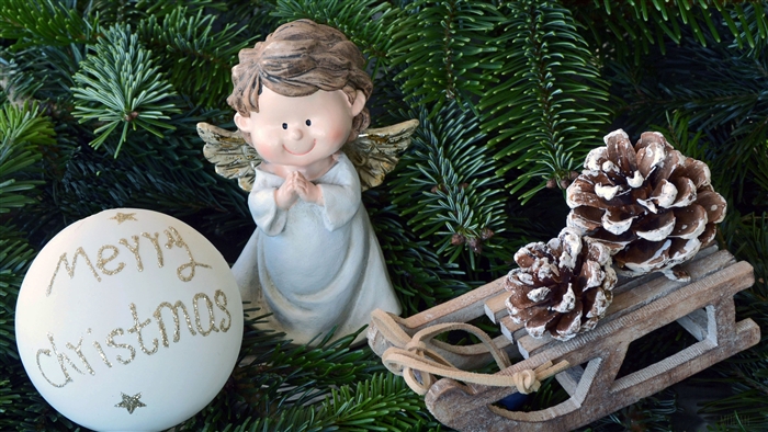 Christmas angel, ornament, and sled with pinecones