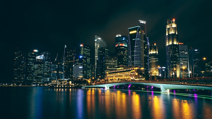 Singapore skyline at night with illuminated skyscrapers and bridge