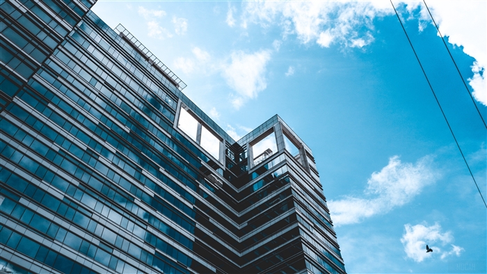 Modern glass building facade against blue sky