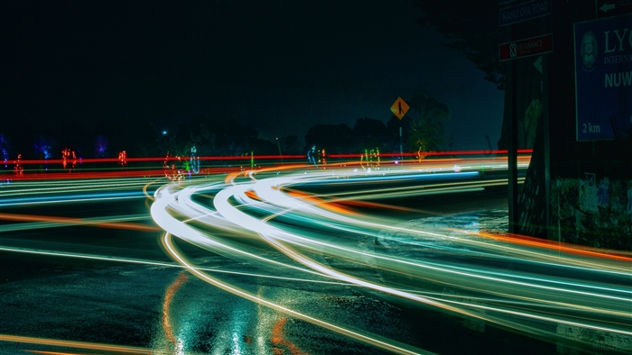 Light trails on a wet road at night