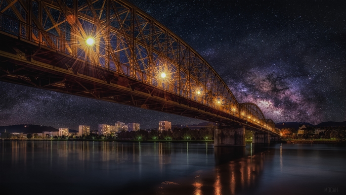 Starry Night Sky Over Illuminated Railway Bridge 4K