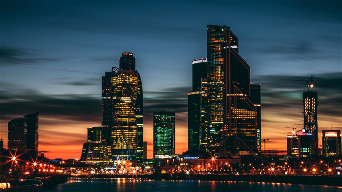 Night city skyline with skyscrapers and river