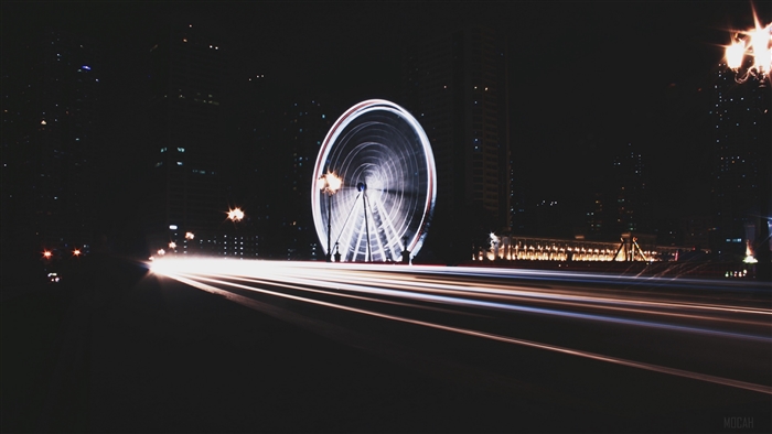 Ferris wheel at night with light trails