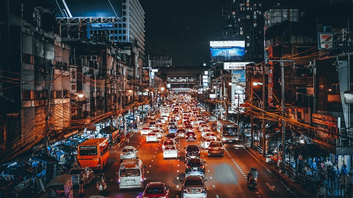 Busy street traffic at night in a city