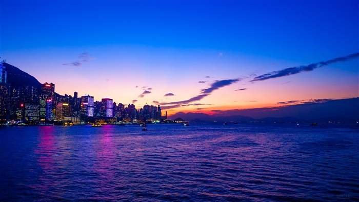 Hong Kong skyline at sunset over the water 4K