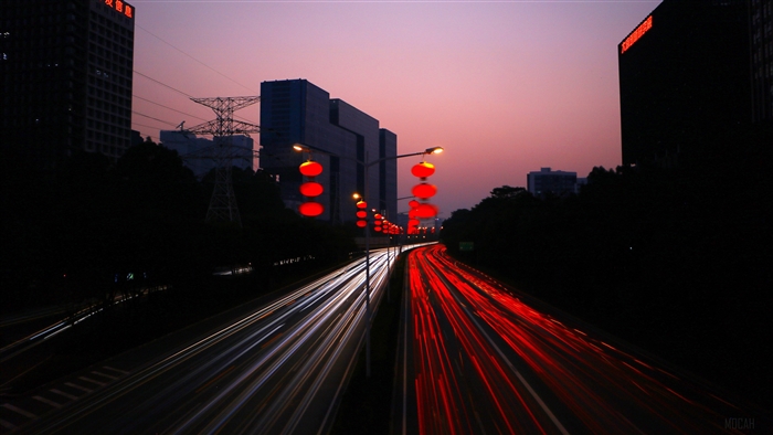 Night city road with light trails and red lanterns